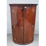 A mid-18th century mahogany hanging bowfront two door corner cabinet, 71cm wide x 117cm high.