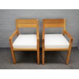 A pair of 20th century beech framed open armchairs, on block supports, 55cm wide x 82cm high, (2).