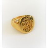 An 18ct gold oval signet ring, seal engraved with a shield surmounted by a coronet, Birmingham 1988,