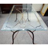 A 20th century wrought iron and glass rectangular dining/ garden table, 90cm wide x 180cm long.