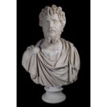 After the Antique; a modern resin bust depicting a man in Roman clothing, on turned socle,