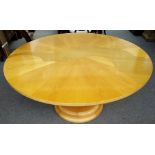 A 20th century circular dining table, with segmented birch veneer top on stepped turned column,