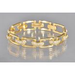 A gold and diamond set bracelet, designed as a series of diamond set curved links,