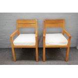 A pair of 20th century beech framed open armchairs, on block supports, 55cm wide x 82cm high.