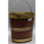 A George III and later brass bound cooper made peat bucket, 34cm wide x 34cm high.