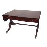 A Regency mahogany sofa table, with two drawers on dual standard supports,
