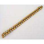 A two colour gold bracelet, in an interwoven herring bone link design, on a snap clasp,