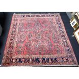 A Sarough carpet, Persian, the pink field with vases of abundantly floral sprays,