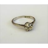 A platinum and diamond set single stone ring, claw set with a cushion shaped diamond,