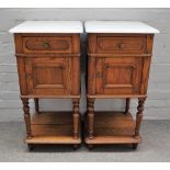 A pair of mid-19th century French marble top bedside tables, with single drawer over cupboard,
