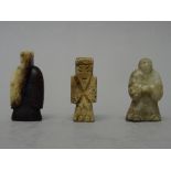 Three small Chinese jade figural carvings, probably Han dynasty, of various tones, two as beads,