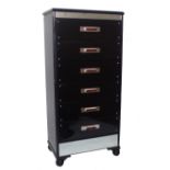 A 20th century ebonised and glass mirror mounted six drawer tall chest, with Bakelite style handles,