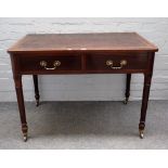 A 19th century mahogany rectangular writing table with pair of frieze drawers on turned tapering