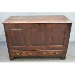 An 18th century oak mule chest with triple panel front over pair of drawers on block feet,
