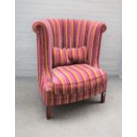 An 18th century style high tub back armchair in striped upholstery, 100cm wide x 108cm high.