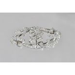 A diamond set double clip brooch, in a pierced shaped oval design,