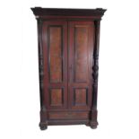 A late 19th century French mahogany folding bed within a double wardrobe,