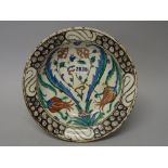 An Iznik pottery dish, Ottoman Anatolia, first half 17th century, painted with polychrome tuilp,