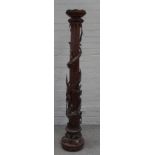 A Chinese carved wood torchere stand, the fluted column encircled in high relief with a dragon,