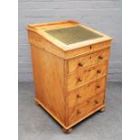 A Victorian satin birch Davenport, the slope top over four long graduated drawers on bun feet,