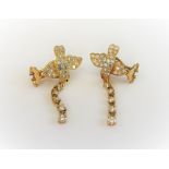A pair of 18ct gold and diamond earclips, each designed as a bird in flight,