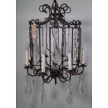 A modern eight branch metal and glass chandelier of octagonal open cage form,