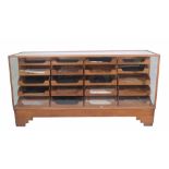 Dudley & Co Ltd; a mid-20th century oak haberdashery cabinet,