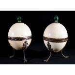 A pair of ostrich egg boxes and covers, with silver plated mounts,