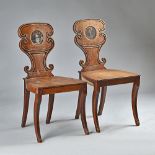 A pair of George III mahogany hall chairs,