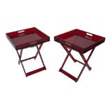 'Shanghai Tang'; a pair of red acrylic folding occasional tables, with galleried tops,