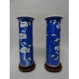 A pair of Chinese blue and white vases cylindrical sleeve vases, late 19th/early 20th century,