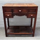 A 20th century Chinese hardwood dressing table with lift top mirror and side compartments over