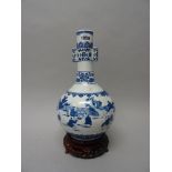 A Chinese blue and white `boys' vase, modern, of bottle form with two lug handles,