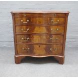 An early 19th century mahogany serpentine chest,