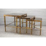 A nest of three 20th century lacquered brass occasional tables on reeded supports,