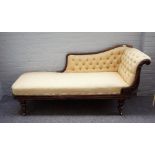 An early Victorian rosewood scroll back chaise longue, on baluster octagonal supports,