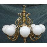 A pair of 18th century style Dutch brass eight branch chandeliers with opaque globular shades,