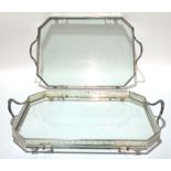 A pair of silver plated twin handled drinks trays, each with pierced gallery border and glass bases,