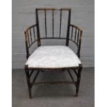 A Regency ebonised ash open armchair with faux bamboo turned decoration, 56cm wide x 88cm high.