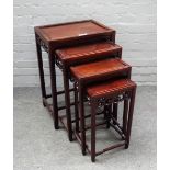 A nest of four late 19th century Chinese hardwood occasional tables with pierced frieze on block