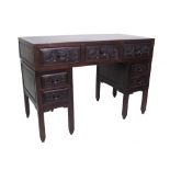 A late 19th century Chinese hardwood pedestal desk, with seven drawers about the knee,