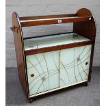 A mid-20th century walnut and coloured glass serving/drinks trolley, 70cm wide x 81cm high.