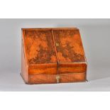 A Victorian figured walnut slope front stationery box with calendar and fitted interior,