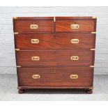 A campaign style brass mounted chest of two short and three long graduated drawers,