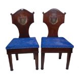 A pair of early 20th century mahogany shield back hall chairs,