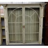 A pair of cream and green painted display cabinets,