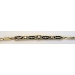 A gold diamond and blue gem set bracelet,