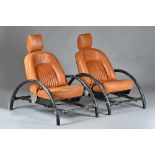 Ron Arad; a pair of Rover chairs, circa 1989, in tan leather upholstery, 70cm wide x 102cm high,
