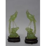 A pair of Chinese bowenite figures of pheasants, 20th century, each standing on a rocky mound, 21.