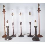 A set of three modern mahogany candlestick table lamps of turned form, 32cm high,